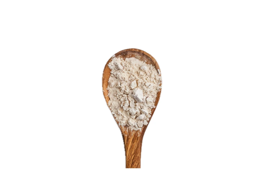 Wooden spoon filled with white flour isolated on white