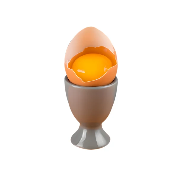Raw cracked egg with yolk in grey egg cup