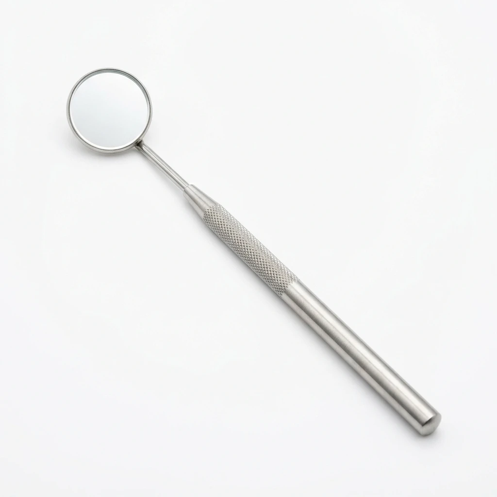 Stainless steel dental mirror on a white background