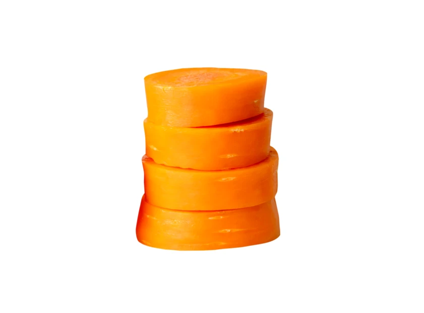 Stack of four circular carrot slices on white background