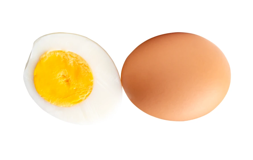 Whole brown egg and half hard-boiled egg isolated on white