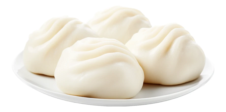 Four steamed Chinese baozi buns on a white plate