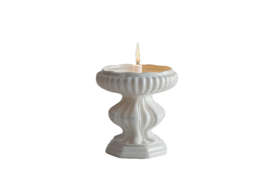 White vintage ceramic oil lamp with lit flame isolated