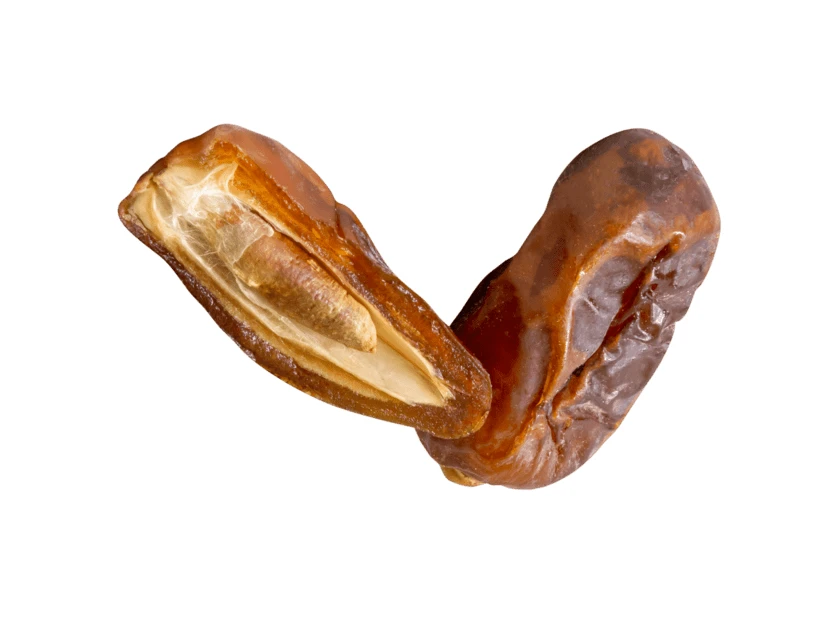 Whole and halved dried dates isolated on white background