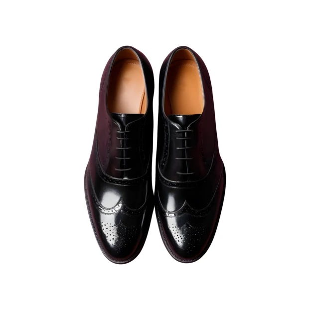 Pair of classic black leather wingtip dress shoes top view