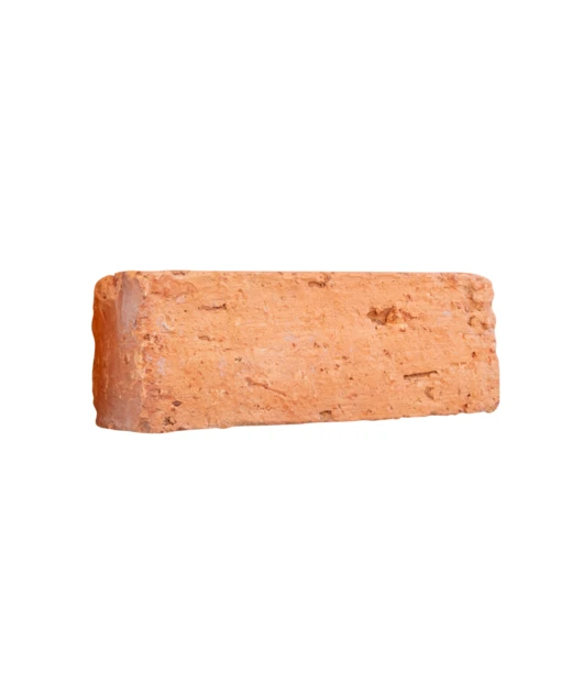 Single red clay brick isolated on white background