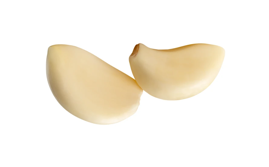 Two peeled garlic cloves isolated on white background