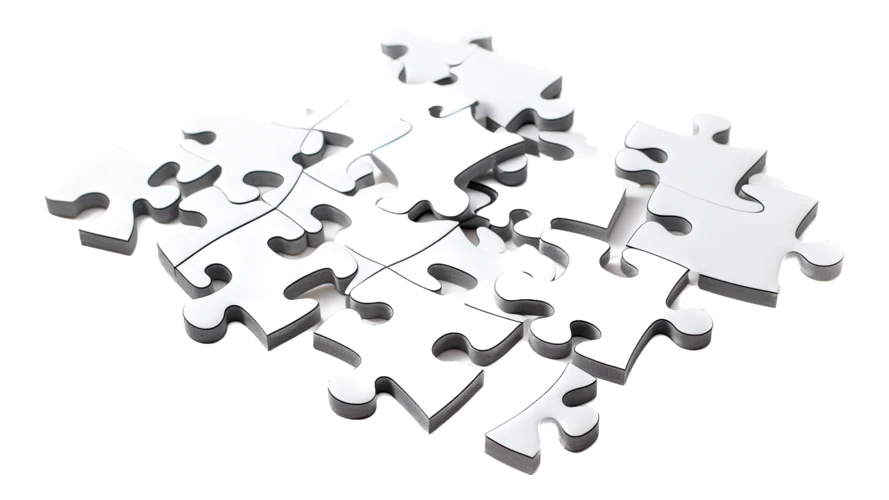 White jigsaw puzzle pieces scattered on white background