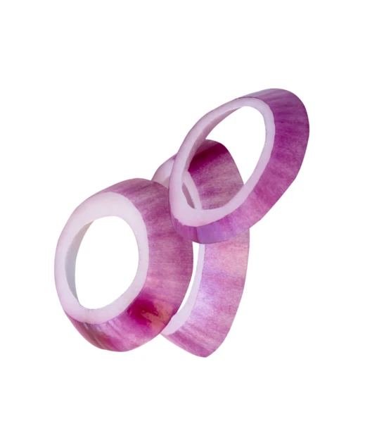 Three red onion rings falling on white background