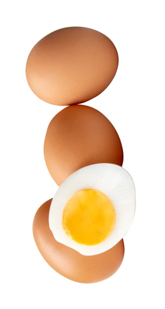 Whole brown eggs and half boiled egg on white background