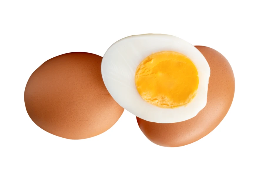 Hard-boiled egg half and two whole brown eggs isolated