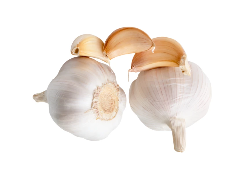 Two whole garlic bulbs and three cloves on white background