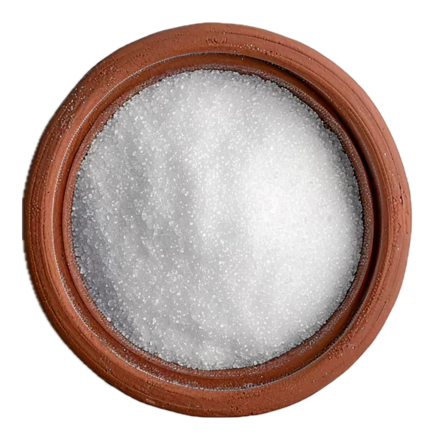 Top view of white granulated sugar in a clay bowl