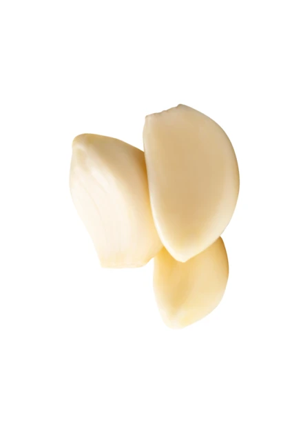 Three peeled fresh garlic cloves isolated on white background