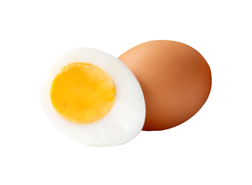 Whole brown egg and hard-boiled egg half on white