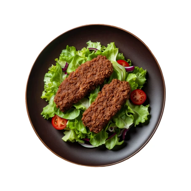 Plant-based breaded strips on fresh green salad isolated