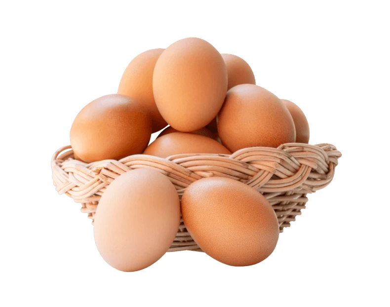 Fresh brown chicken eggs in a wicker basket isolated