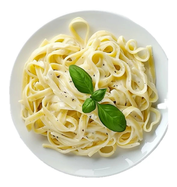 Creamy fettuccine alfredo with basil on white plate isolated