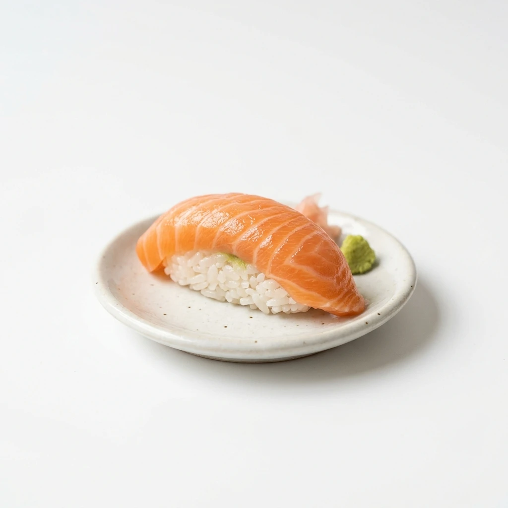 Salmon nigiri sushi with wasabi and ginger on white plate