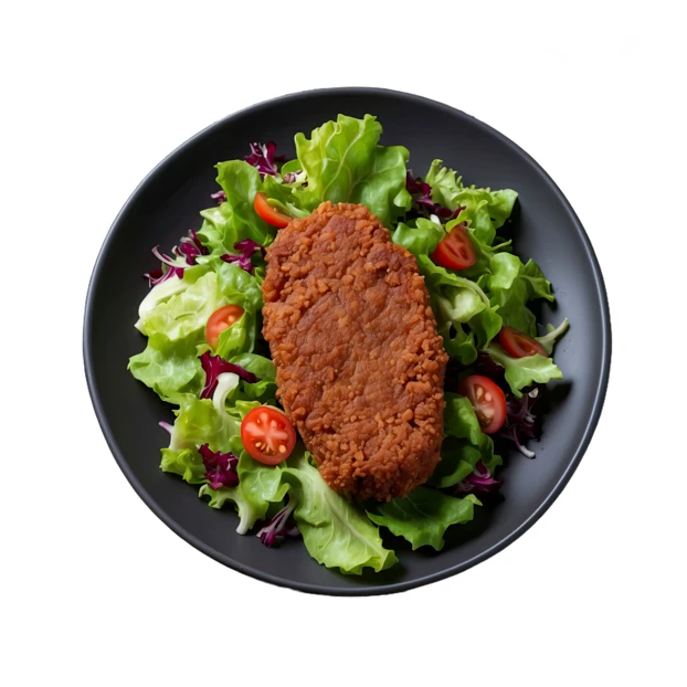 Breaded cutlet served on fresh garden salad top view