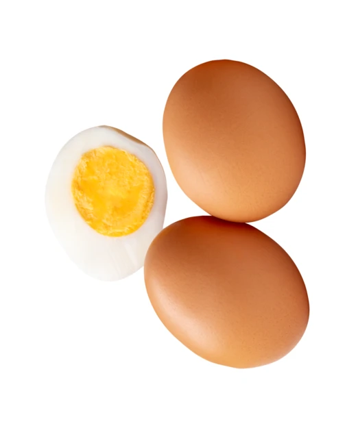 Two brown eggs and a hard boiled egg half isolated