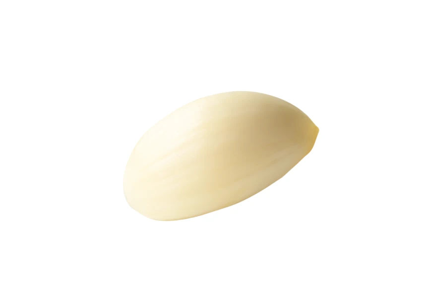 Single peeled garlic clove isolated on white background