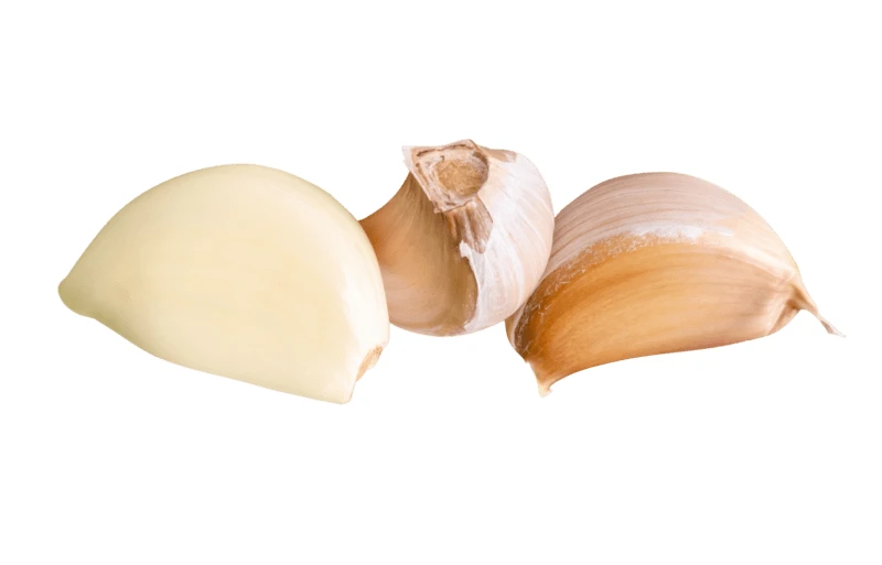 Peeled and unpeeled garlic cloves on white background