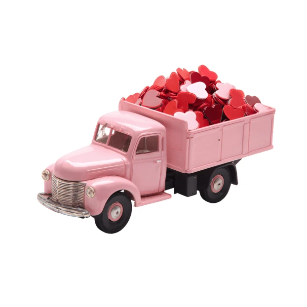 Vintage pink toy truck filled with red and pink hearts