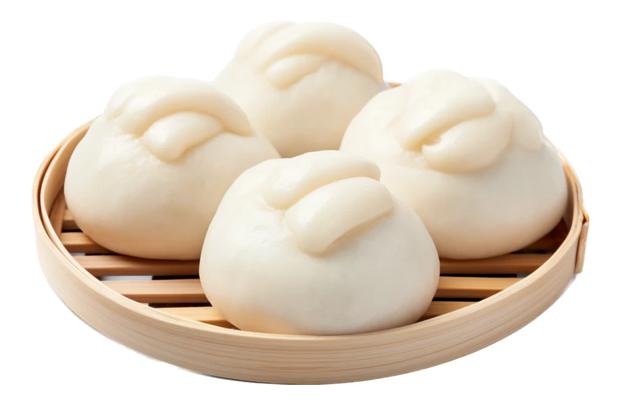 White steamed bao buns in a bamboo steamer tray