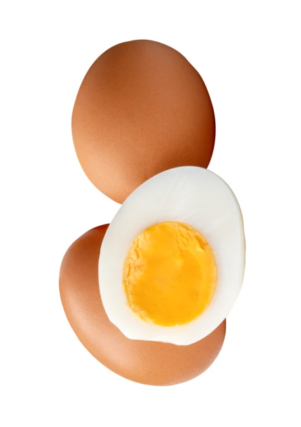 Whole brown egg and hard-boiled egg half on white background