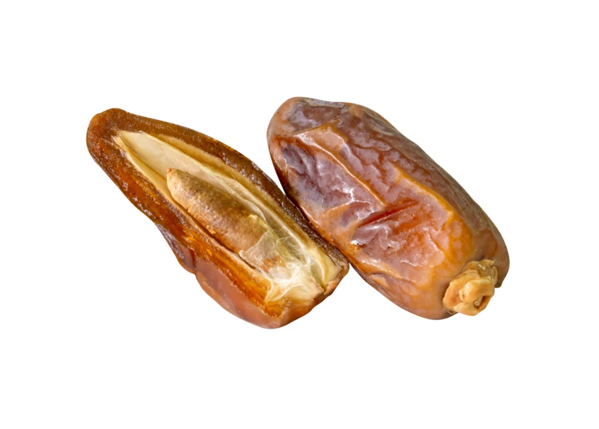 Whole and halved dried dates isolated on white background
