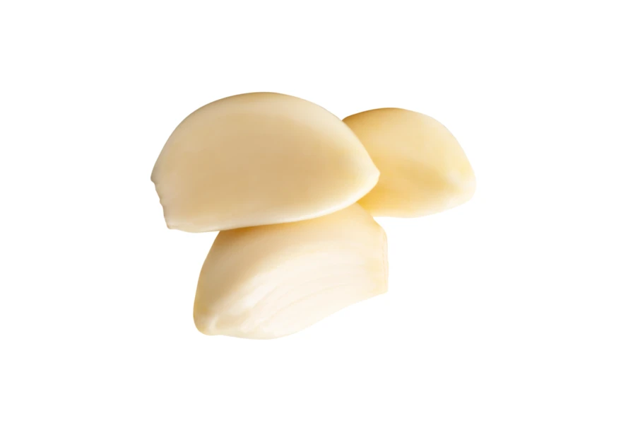 Three peeled garlic cloves isolated on white background