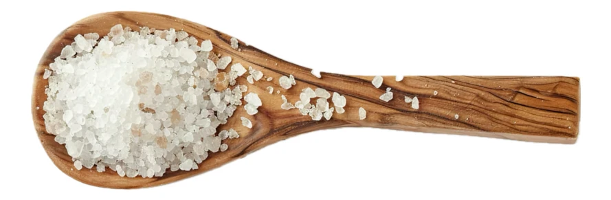 Coarse sea salt in an olive wood spoon isolated