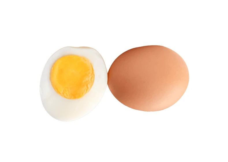 Whole brown egg and hard-boiled egg half on white background