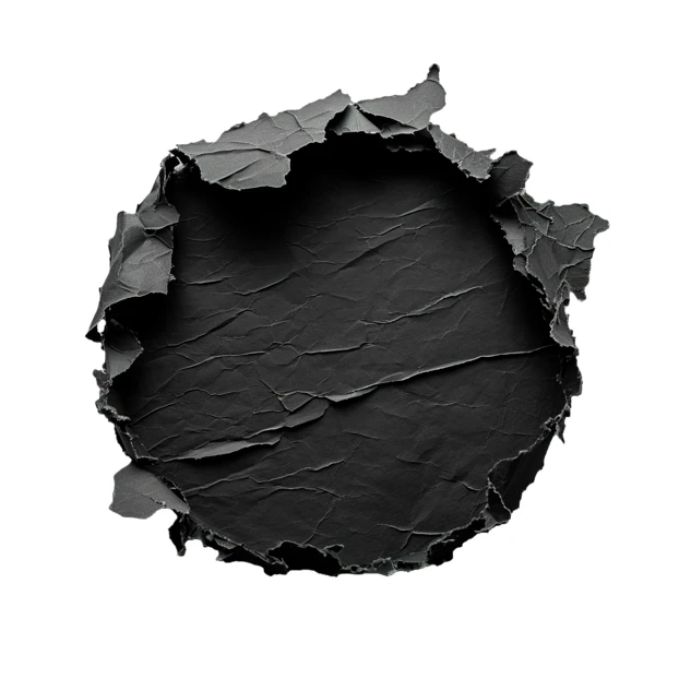 Round torn hole in white paper revealing black textured background