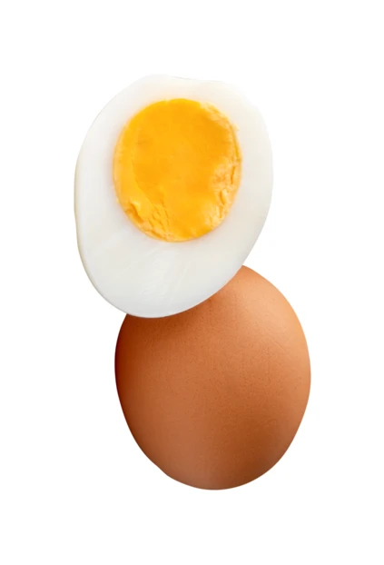 Whole brown egg and half hard-boiled egg isolated on white