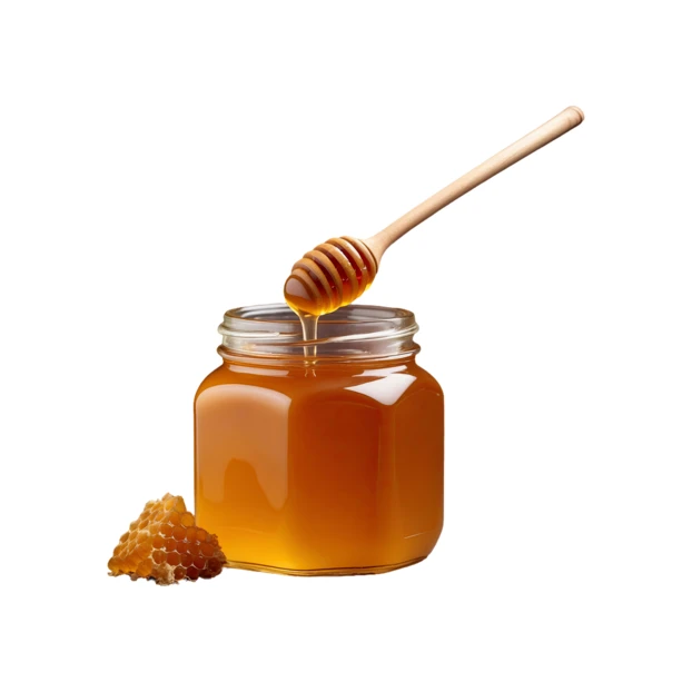 Glass jar of organic honey with wooden dipper and honeycomb