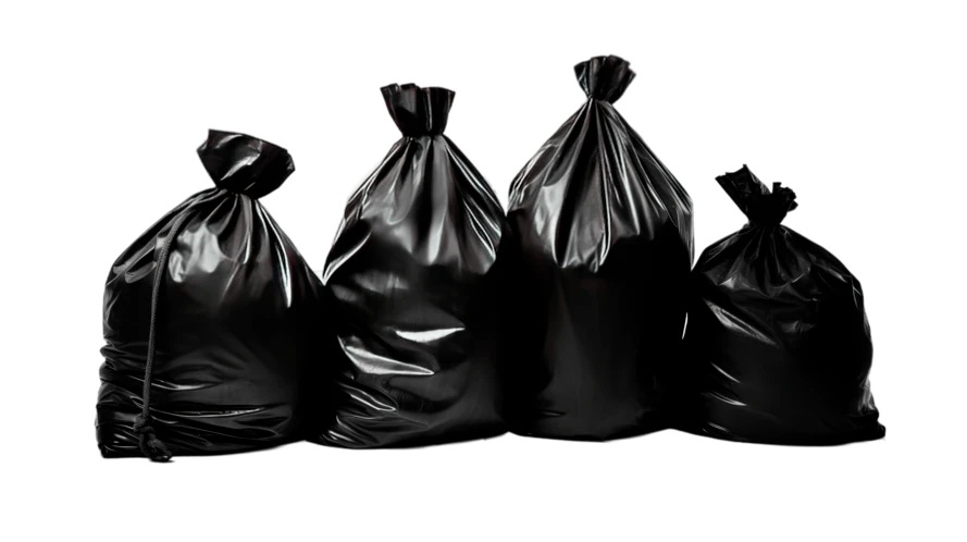 Four full black plastic garbage bags on white background