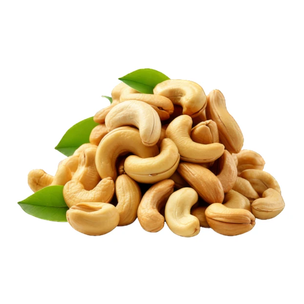 Pile of roasted cashew nuts with leaves isolated on white