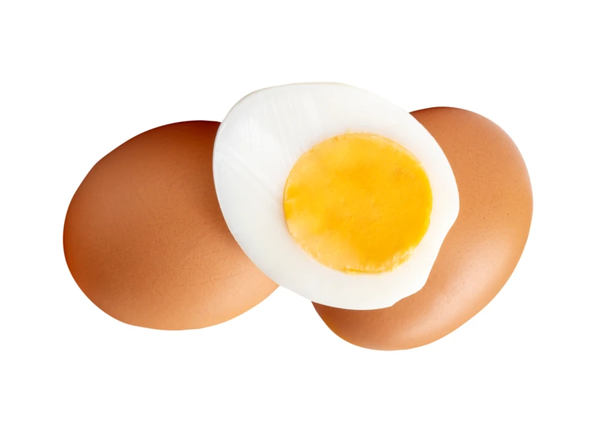 Whole brown eggs and one hard boiled egg half