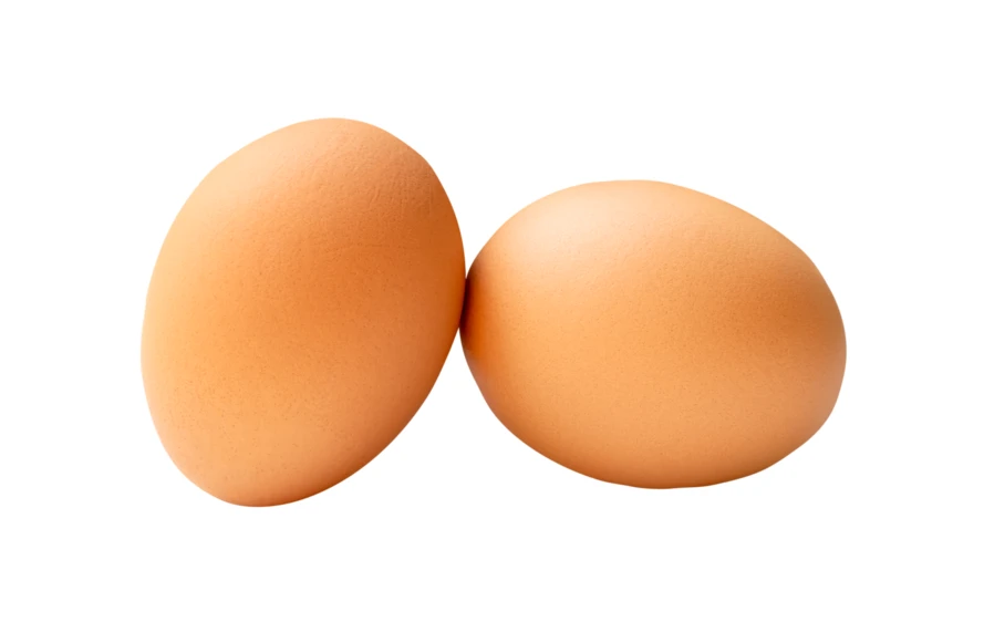Two brown eggs isolated on a white background
