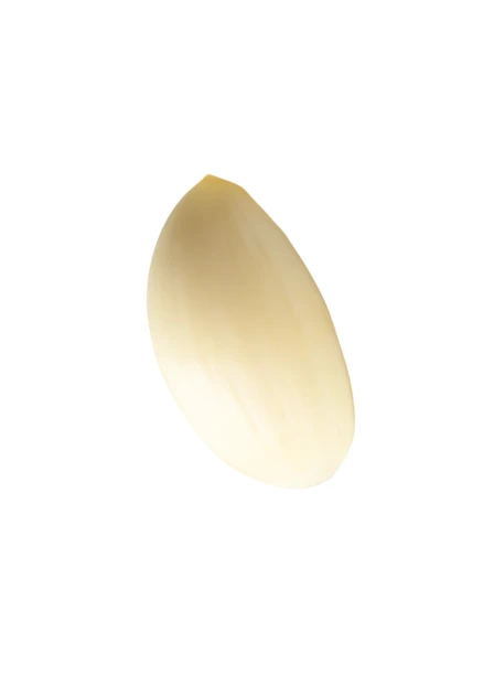 Single peeled garlic clove isolated on white background