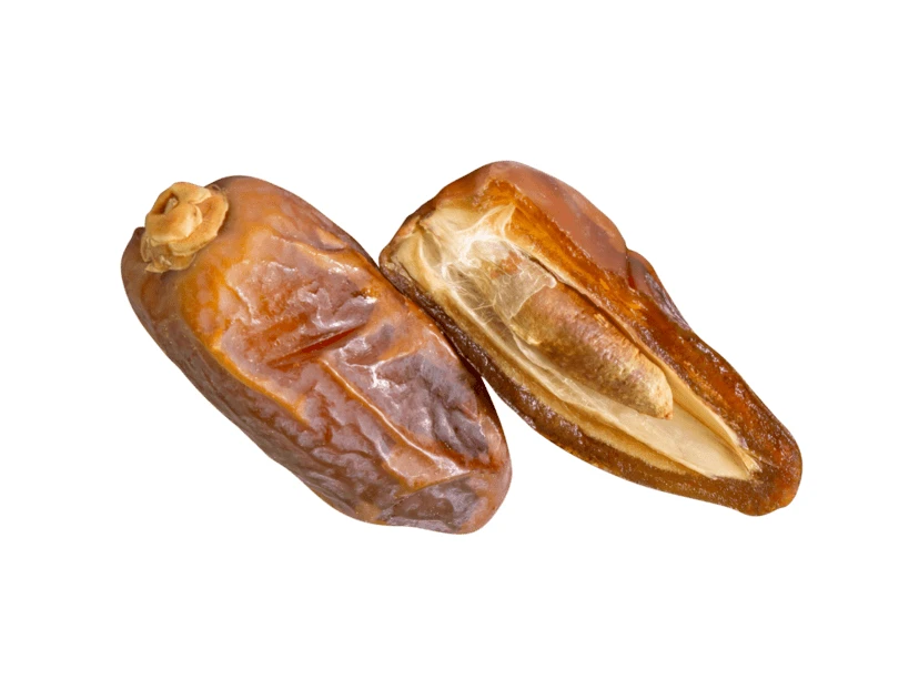 Whole and halved dried dates isolated on white background