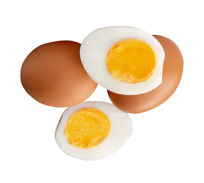 Hard-boiled egg halves and whole brown eggs isolated on white