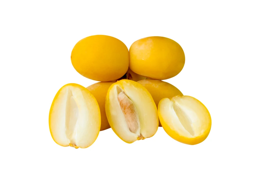 Fresh yellow Barhi dates whole and halved on white background