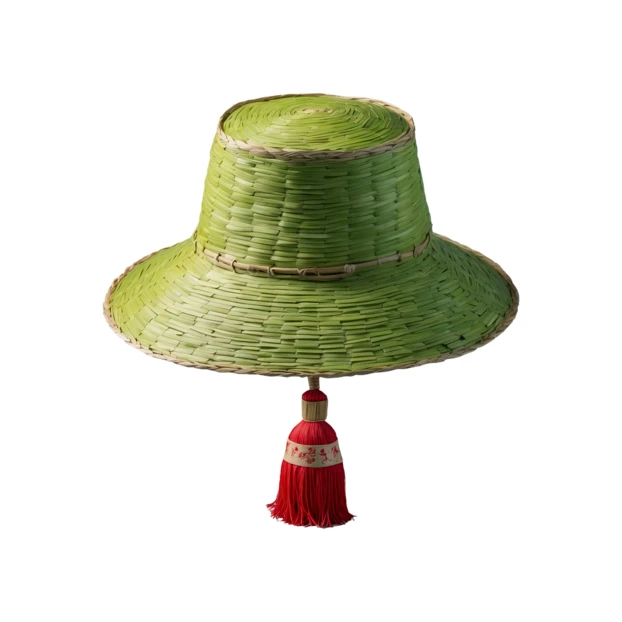 Green woven straw hat with red tassel on white background