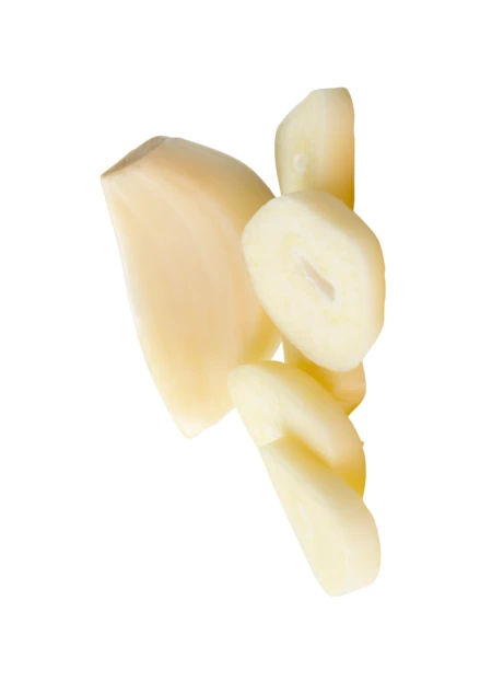 Sliced fresh garlic cloves isolated on white background
