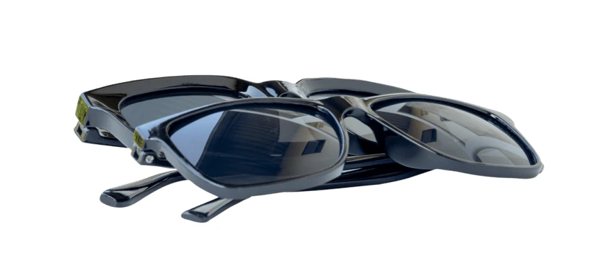 Two pairs of black sunglasses isolated on white background