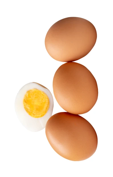 Three whole brown eggs and one hard boiled egg half