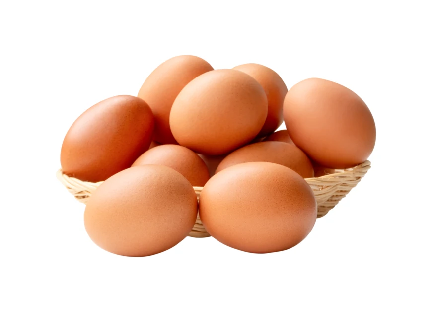 Fresh brown chicken eggs in a wicker basket isolated on white